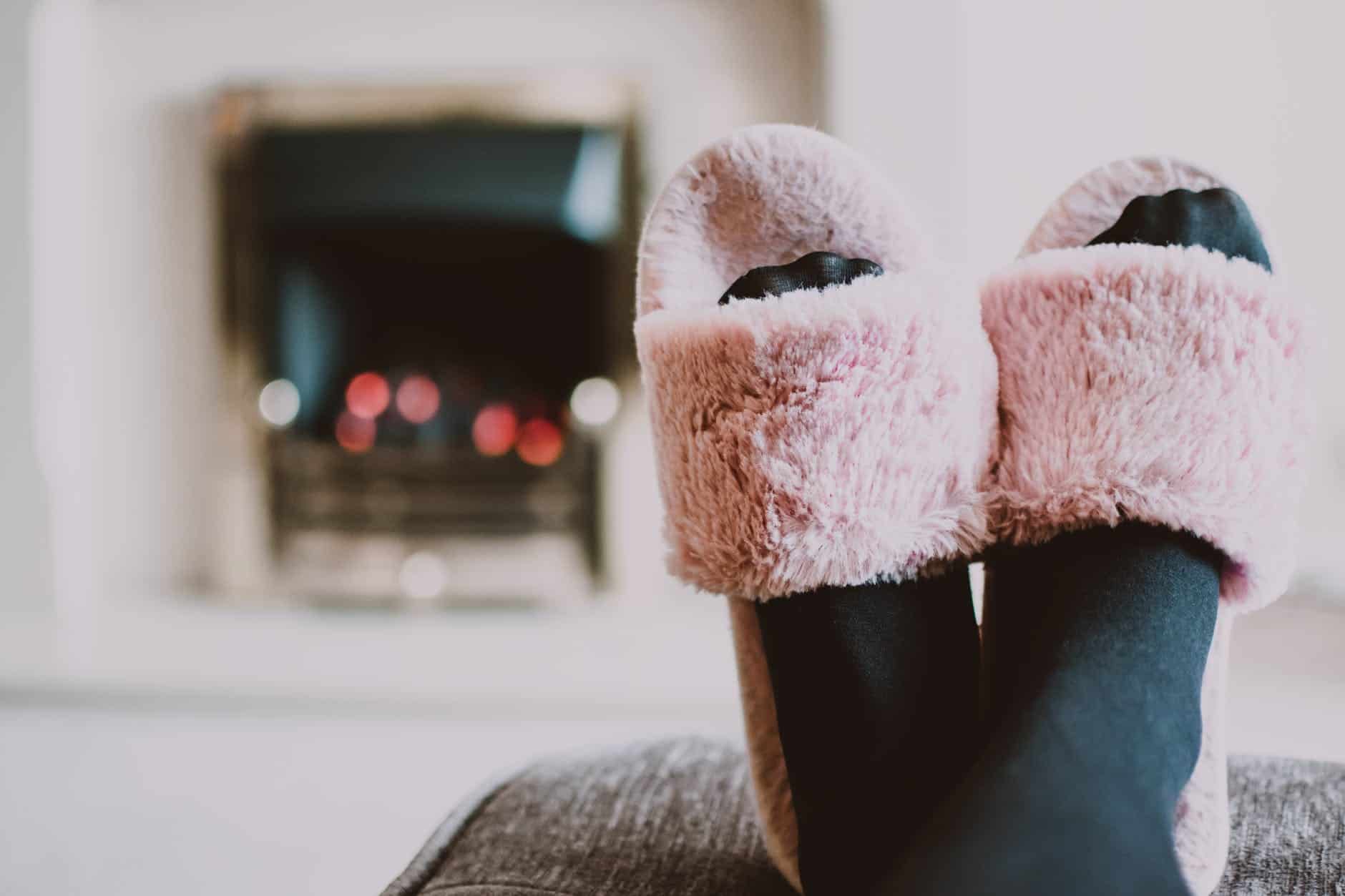 close up photography of person wearing pink house slippers