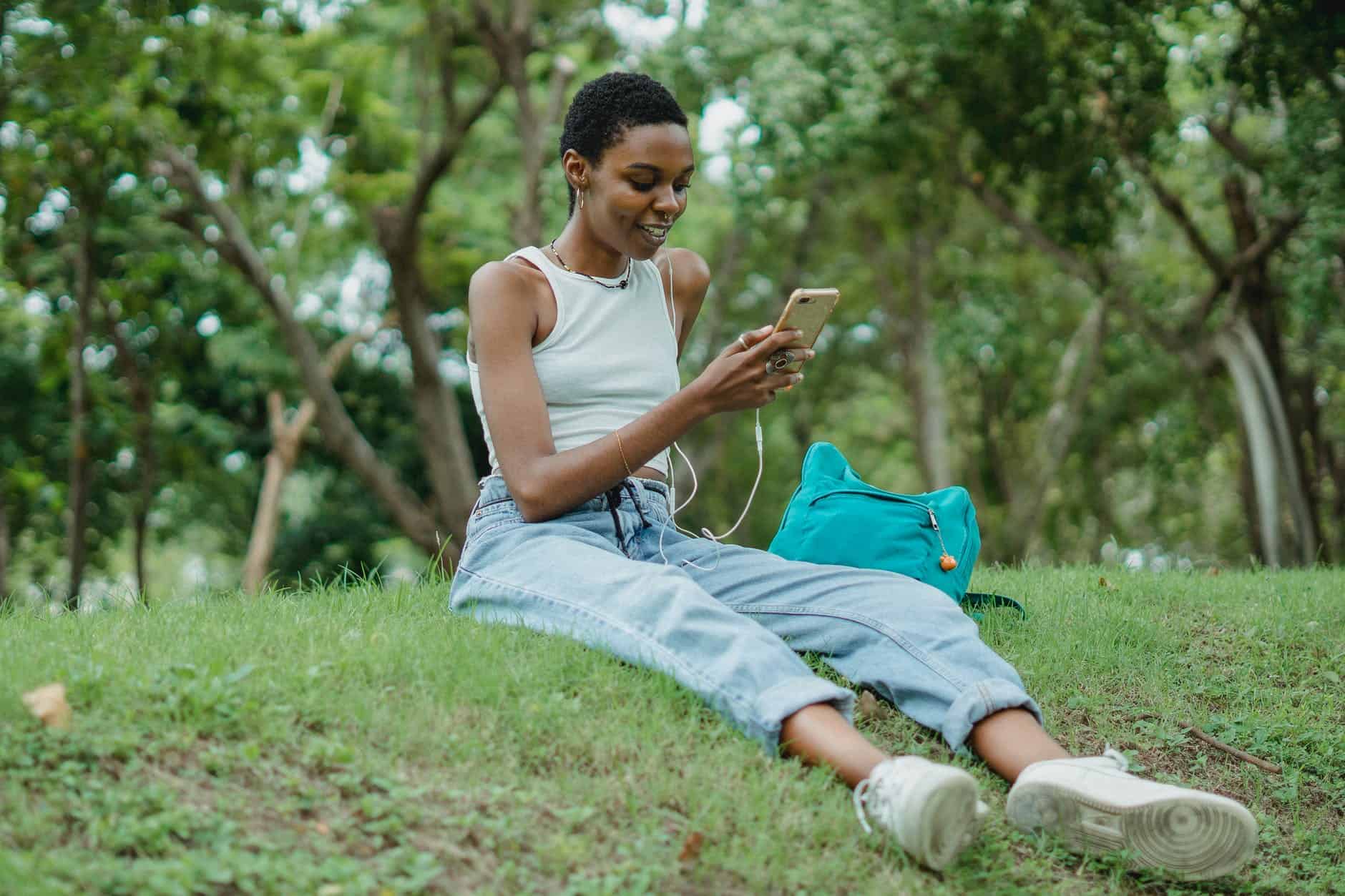 black woman listening to music via smartphone