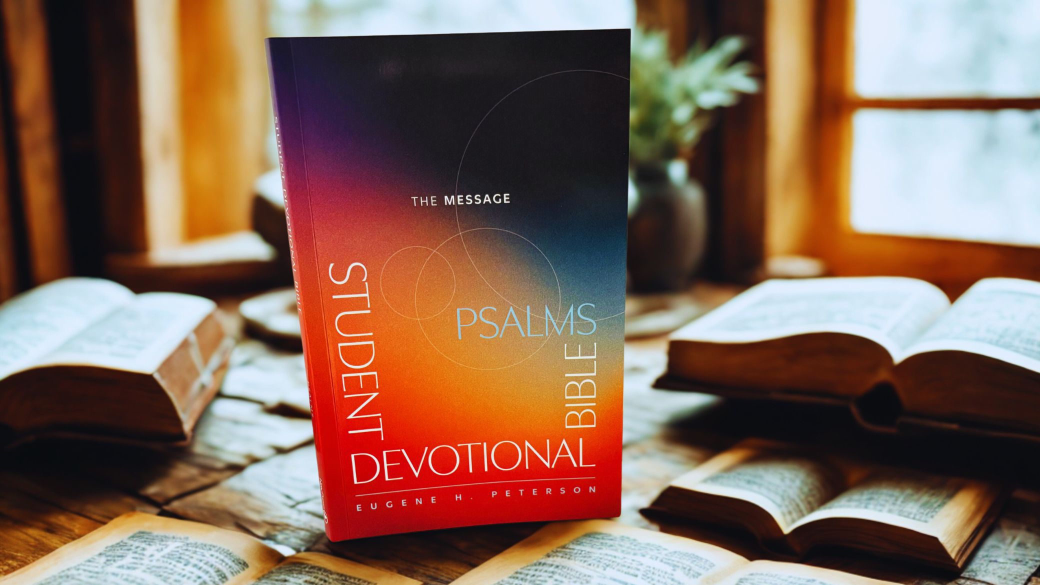 The Message Student Devotional Bible: Psalms Edition open to a psalm page, showing modern paraphrased translation with devotional notes and reflection questions for students